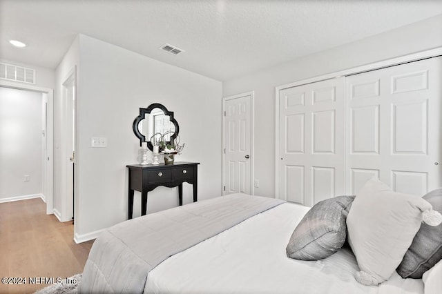 bedroom with a closet and light wood-type flooring