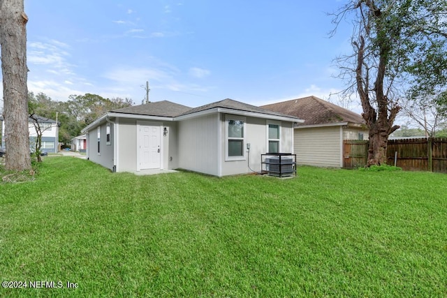 rear view of house with a lawn