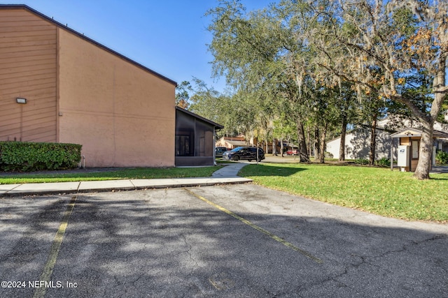 view of property exterior featuring a lawn