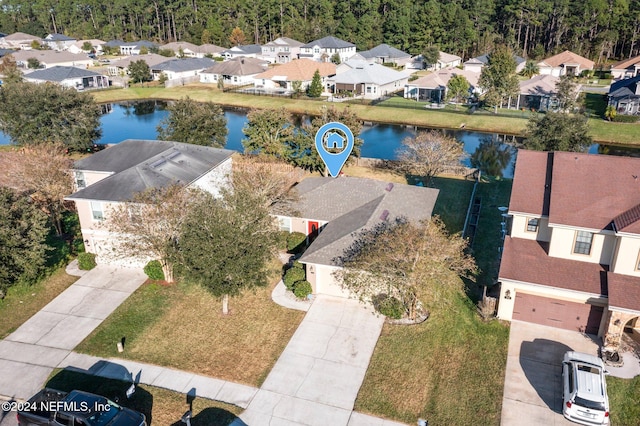 birds eye view of property with a water view