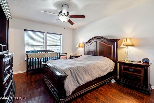 bedroom featuring a textured ceiling, ceiling fan, and dark wood-type flooring