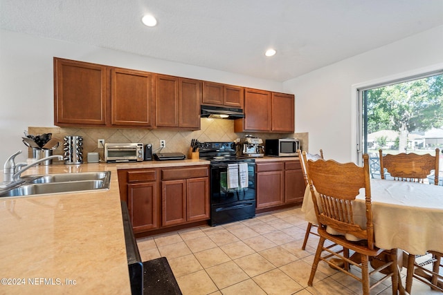 kitchen with backsplash, sink, light tile patterned flooring, and black range with electric cooktop