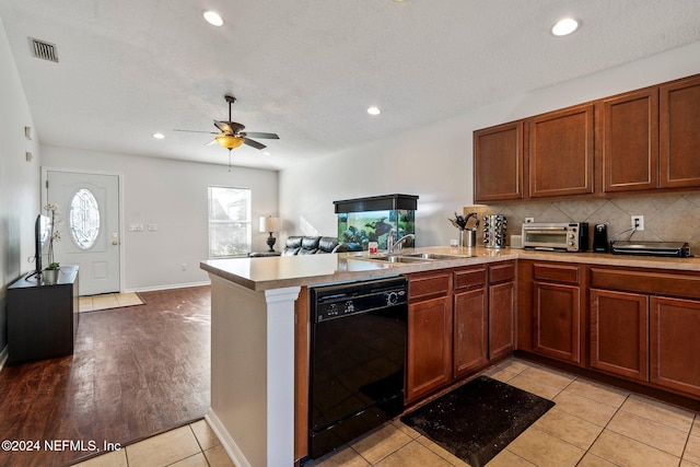 kitchen featuring kitchen peninsula, ceiling fan, sink, light hardwood / wood-style flooring, and dishwasher