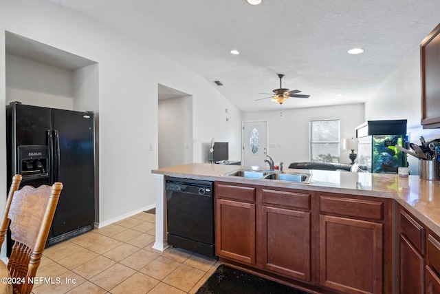 kitchen featuring ceiling fan, sink, a textured ceiling, vaulted ceiling, and black appliances