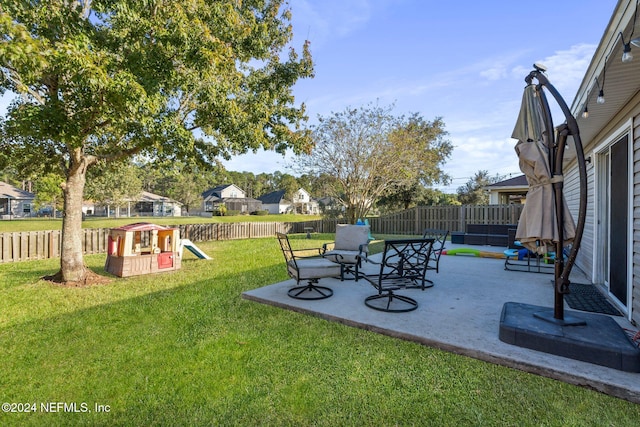 view of yard featuring a patio and a playground