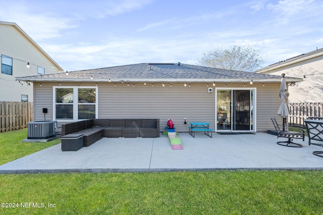 rear view of house featuring a lawn, cooling unit, a patio, and an outdoor hangout area