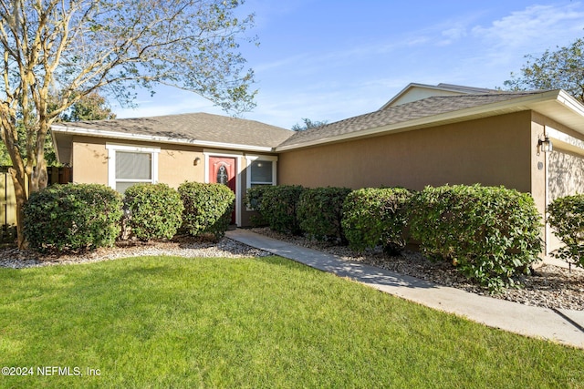 single story home with a garage and a front yard