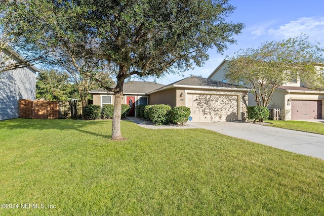 ranch-style house featuring a garage and a front lawn