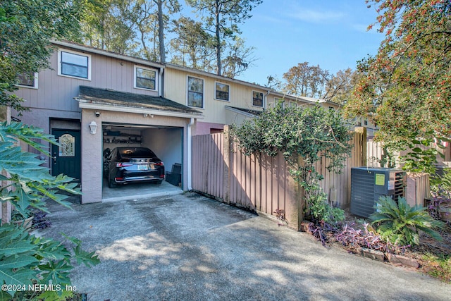 view of front of house featuring central AC and a garage