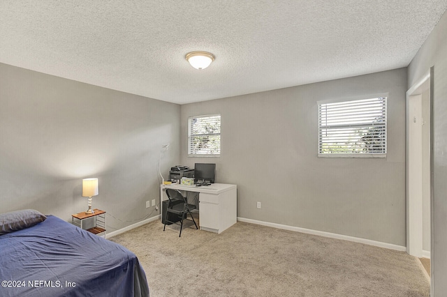 carpeted bedroom featuring a textured ceiling