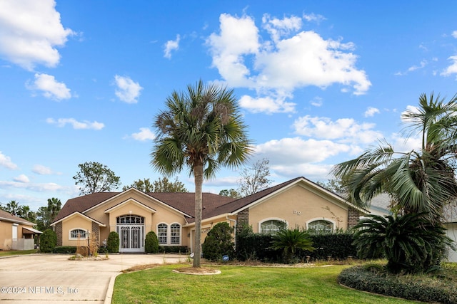 ranch-style house with french doors and a front lawn