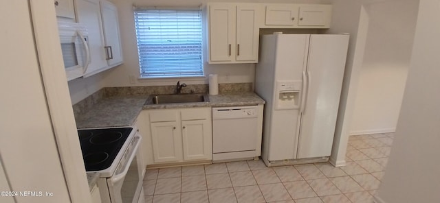 kitchen featuring white cabinets, light tile patterned flooring, white appliances, and sink