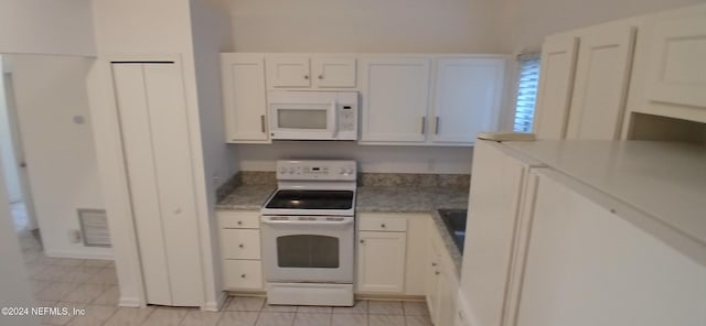 kitchen with white cabinetry and white appliances