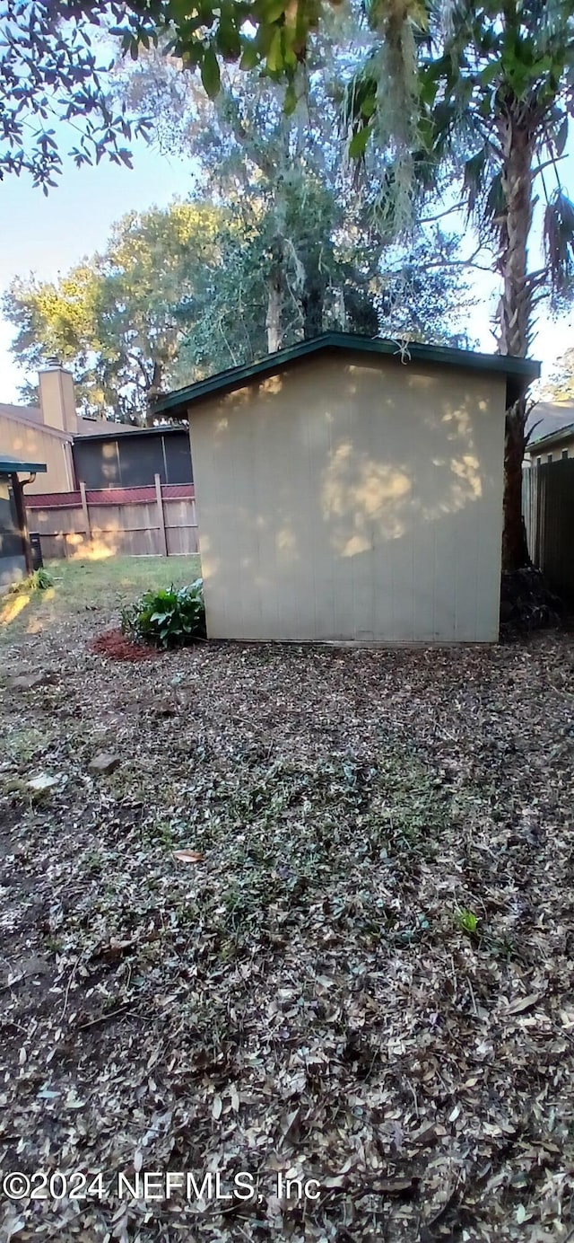 view of side of property featuring a storage shed