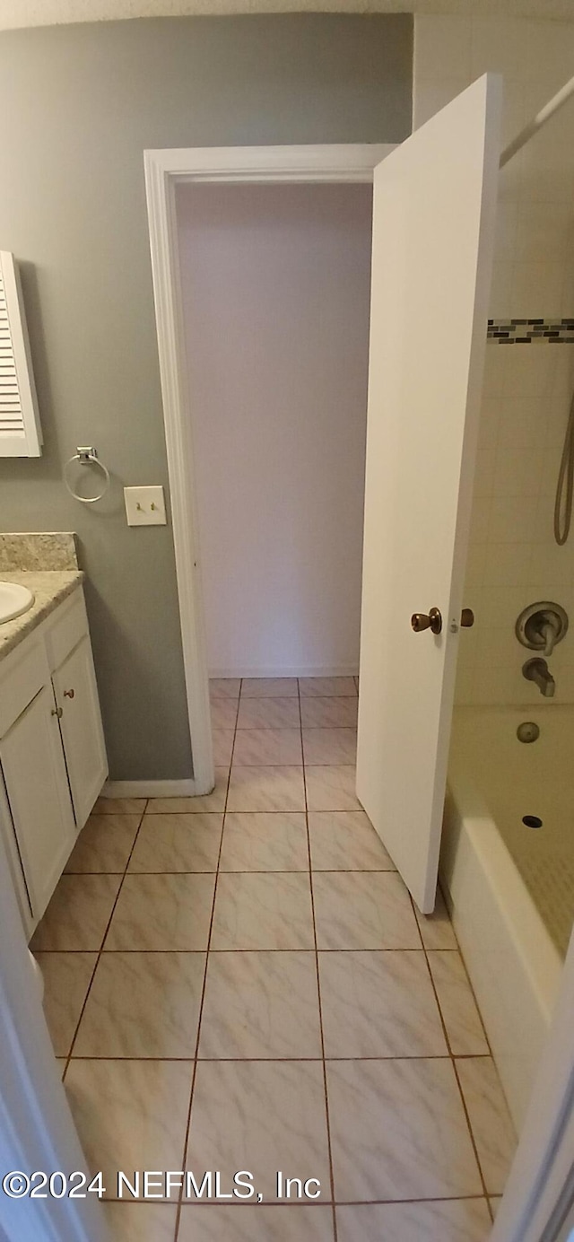 bathroom featuring tile patterned floors, vanity, and tiled shower / bath combo