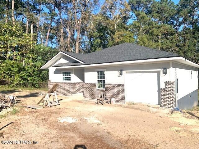 rear view of house featuring a garage