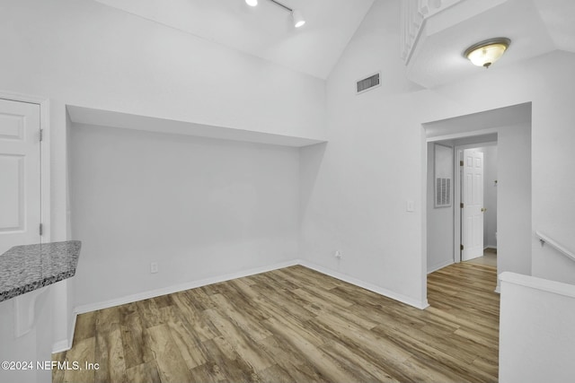 interior space featuring light hardwood / wood-style floors and vaulted ceiling