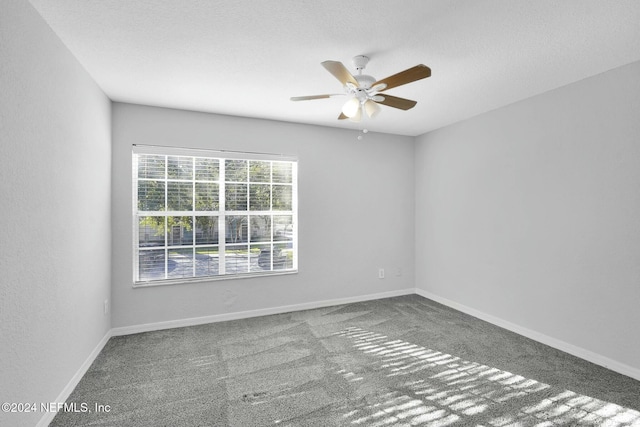 spare room with ceiling fan, carpet floors, and a textured ceiling