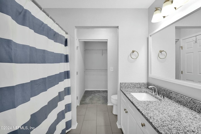 bathroom featuring toilet, vanity, and tile patterned floors