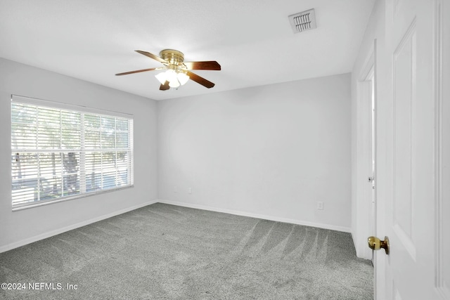 spare room featuring carpet and ceiling fan