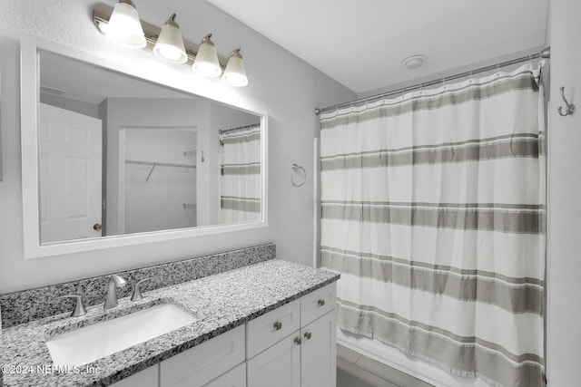 bathroom featuring shower / bath combination with curtain and vanity