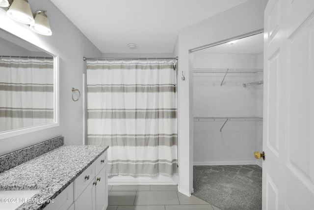 bathroom with tile patterned floors, vanity, and shower / tub combo