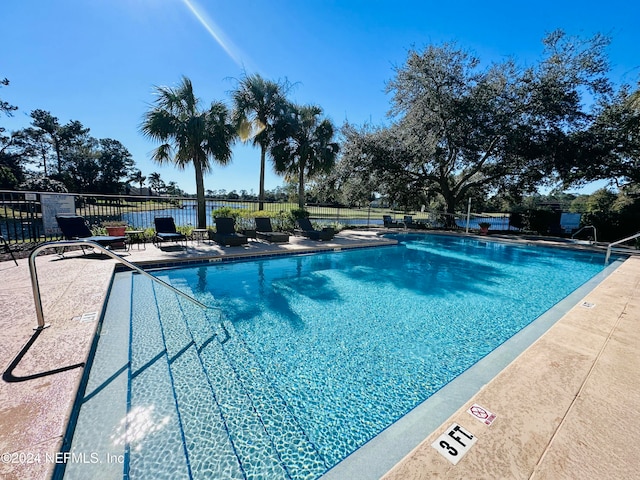 view of swimming pool with a patio area