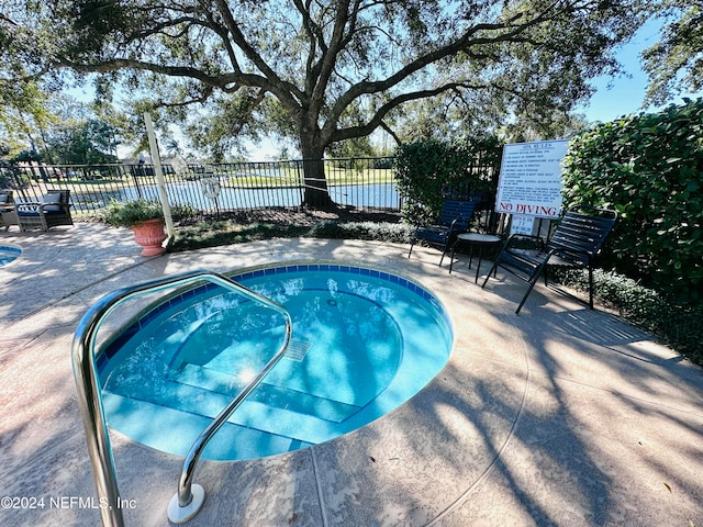 view of pool featuring a community hot tub