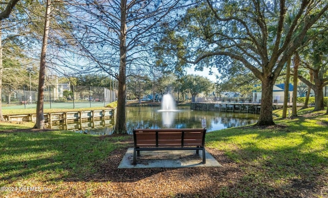 view of home's community featuring a water view and a yard