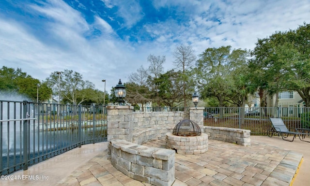 view of patio / terrace with a water view and a fire pit