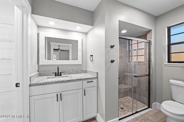 bathroom with tile patterned floors, vanity, toilet, and walk in shower