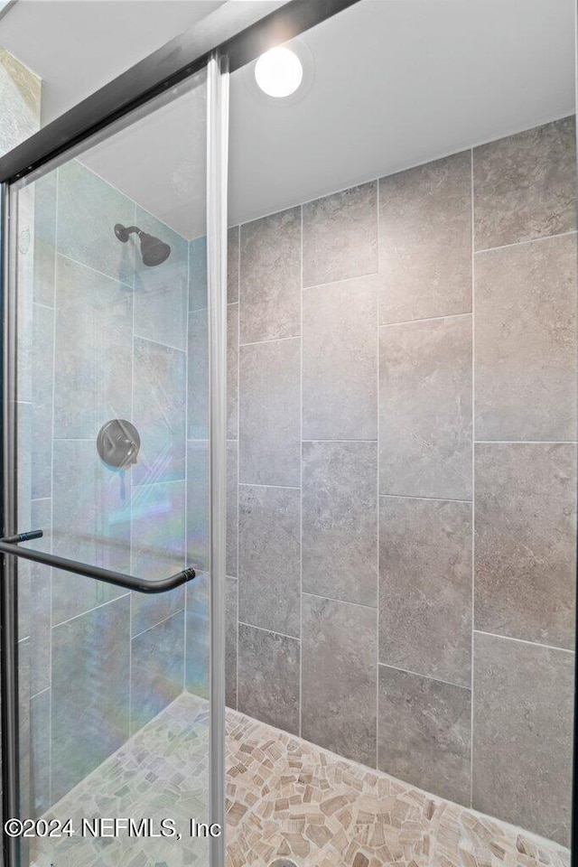 bathroom with a shower with shower door