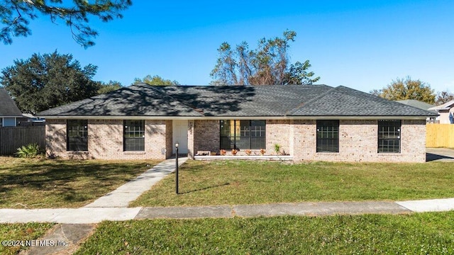 ranch-style home with a front lawn