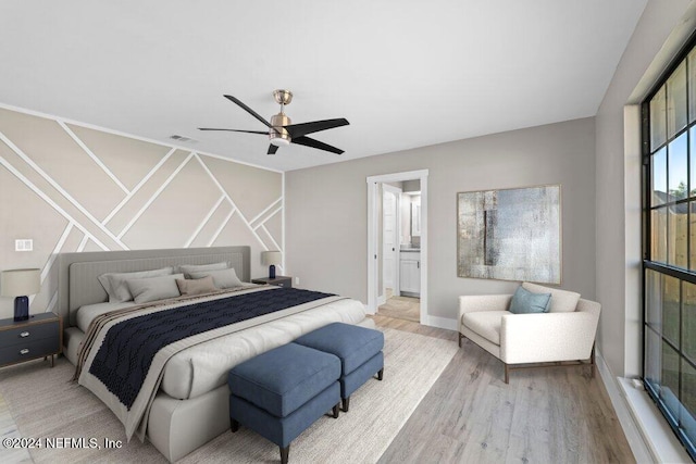 bedroom with ceiling fan, ensuite bath, and light hardwood / wood-style flooring