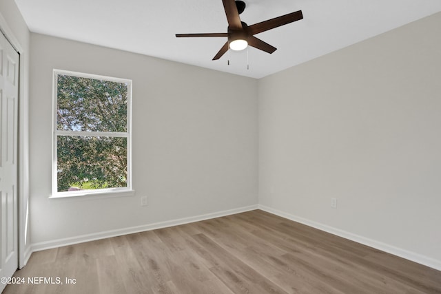 empty room with ceiling fan and light hardwood / wood-style floors