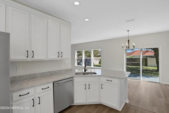 kitchen with kitchen peninsula, appliances with stainless steel finishes, sink, wood-type flooring, and white cabinets