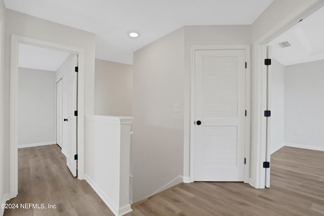 hallway with light hardwood / wood-style flooring