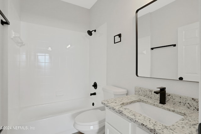 full bathroom with vanity, tiled shower / bath combo, and toilet