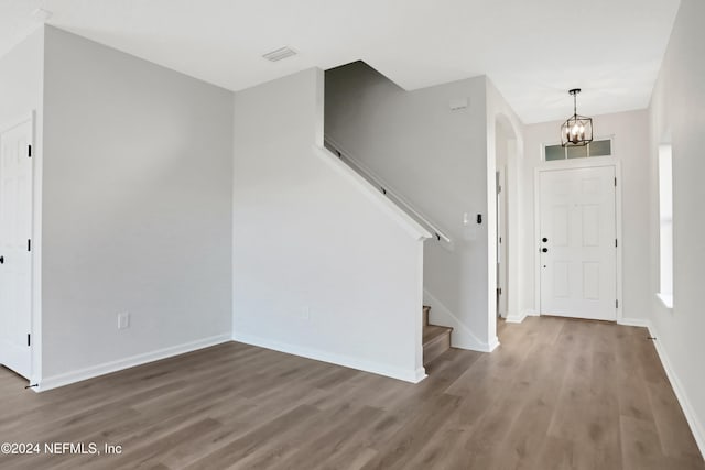 entryway featuring a notable chandelier and hardwood / wood-style flooring