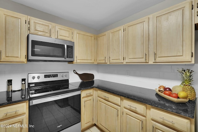 kitchen with appliances with stainless steel finishes, light brown cabinets, and backsplash