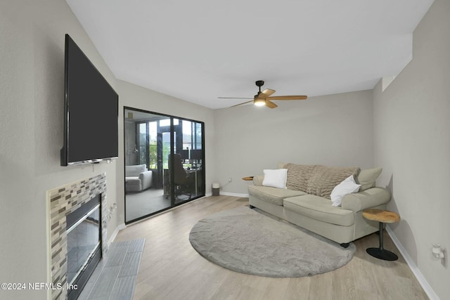 living room with ceiling fan and light hardwood / wood-style flooring