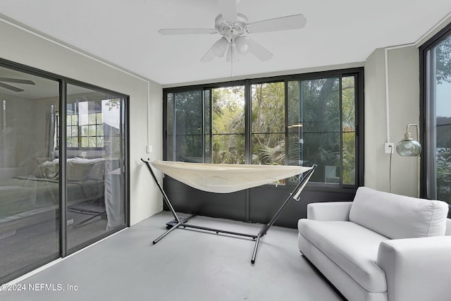 sunroom / solarium featuring ceiling fan and a healthy amount of sunlight