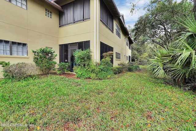 view of side of home featuring a yard