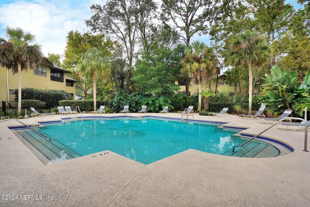 view of pool featuring a patio