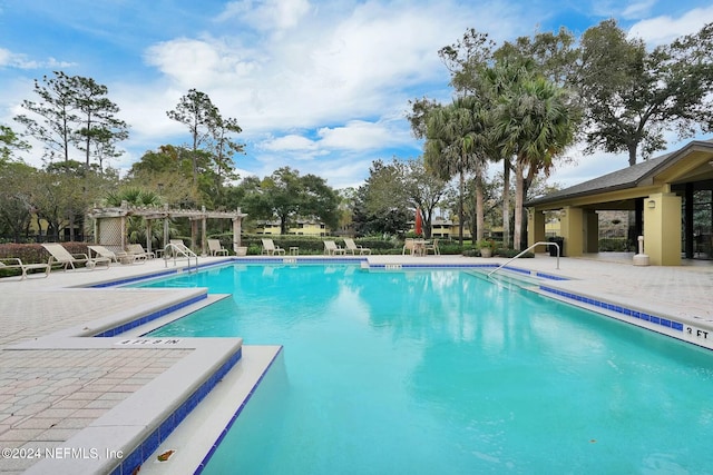 view of pool with a pergola and a patio