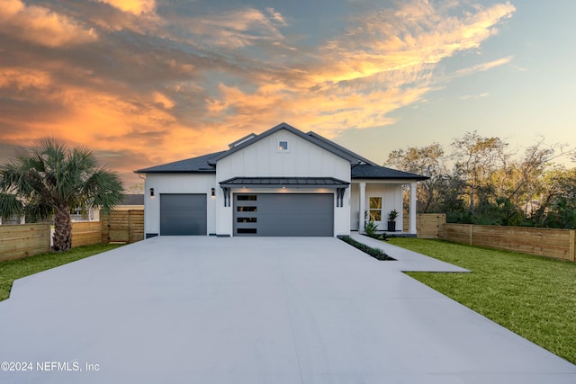 view of front facade with a lawn and a garage