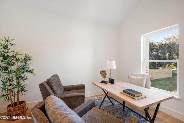 office space featuring hardwood / wood-style floors and vaulted ceiling