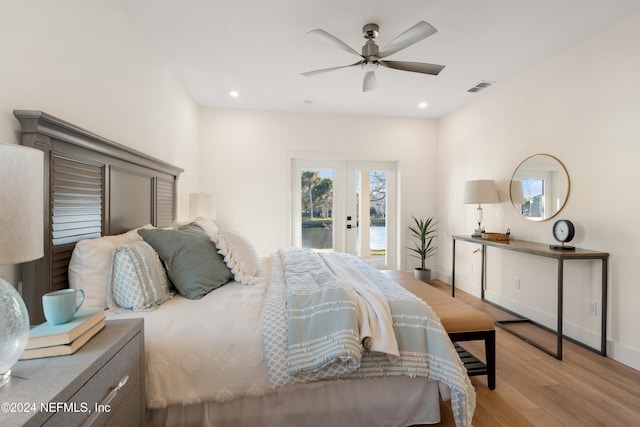 bedroom with ceiling fan, light hardwood / wood-style floors, access to outside, and french doors