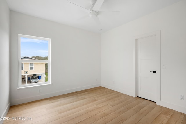 empty room featuring ceiling fan and light hardwood / wood-style flooring