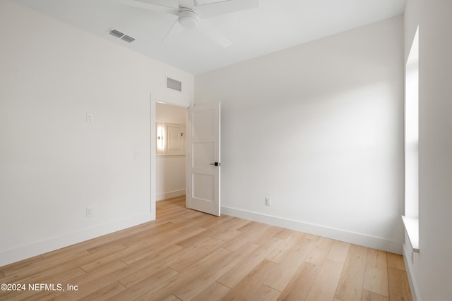 spare room featuring ceiling fan and light hardwood / wood-style floors